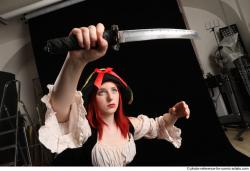 DARINA KNEELING POSES WITH DAGGER 